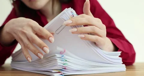 Manager deletes business documents and works with documentation Stock Footage 294600966