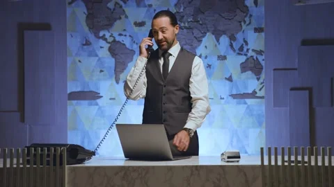 A manager at desk, taking reservations, orders Stock Footage 233994686