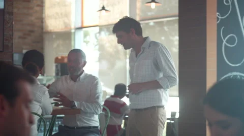 Manager discussing with customers at cafe. Stock Footage 64094614