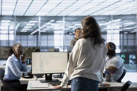 Manager discussing with data center employees, making announcement Stock Photos
