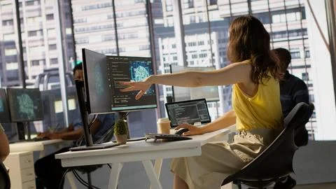 Manager discussing with employees in office, developing artificial intelligence Stock Photos
