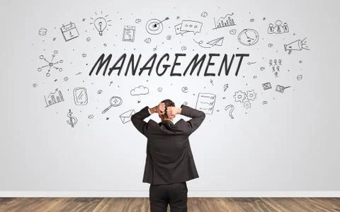 Manager in doubt looking to a wall with business concept 库存照片