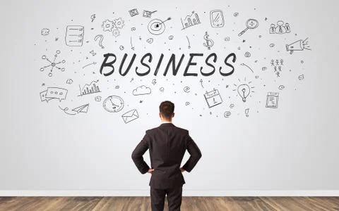 Manager in doubt looking to a wall with business concept 库存照片