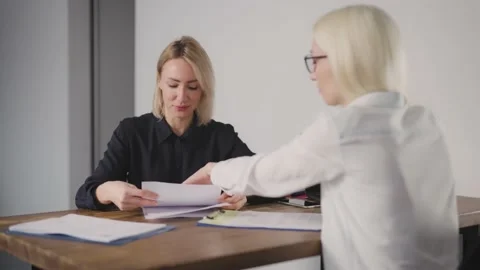 The manager draws up a package of documents to the client Stock Footage 171963434