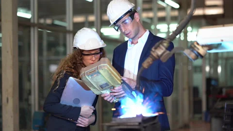Manager engineer control  Welding robot arms machine discuss with business wo Stock Footage 154484392