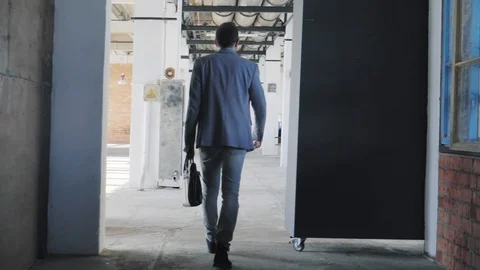 The manager enters the creative office space, welcomes and communicates with a Stock Footage 109416818