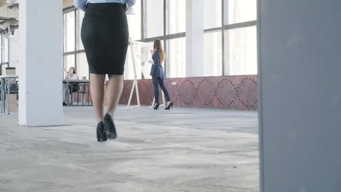 The manager enters the loft-style office space and greets the colleagues. Office Stock Footage 109502697