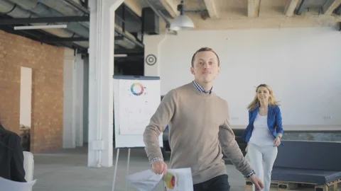 The manager enters the office in a great mood and dances. Colleagues get up from Stock Footage 124656863