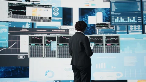 Manager evaluating business market graphs using laptop software Stock Footage 318934816