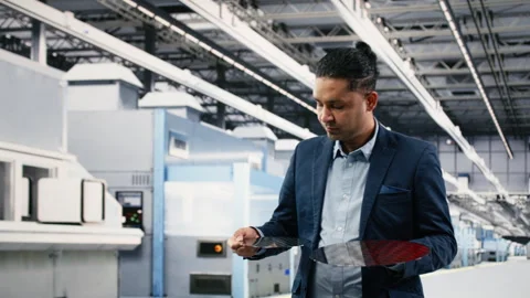 Manager examining semiconductor substrates, walking in cleanroom Stock Footage 333394836