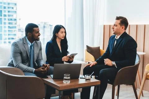 Manager explain about project while worker use tablet analysis data. Ornamented. Stock Photos