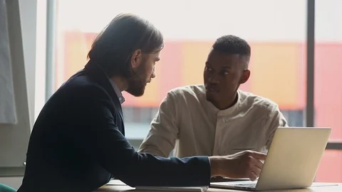 Manager explaining corporate software to young african american employee. Video stock 124738895