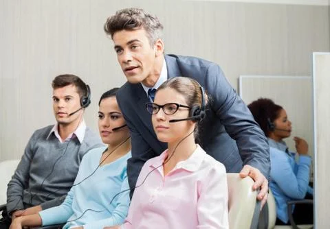 Manager Explaining To Employee In Call Center Stock Photos