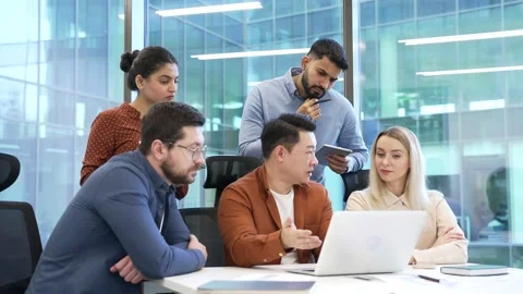 Manager explains startup project details to group of workers using laptop  Stock Footage 301973346