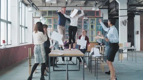 The manager gets up on the table and starts to dance. Employees dance with him Stock Footage 108215382