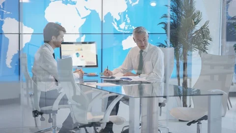 Manager giving a presentation to his colleagues during a meeting Stock Footage 108105320