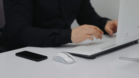 The manager got a message on the smartphone, behind the office computer Stock Footage 106498498