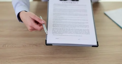 Manager handing client contract for signature closeup 4k movie slow motion Vídeos de archivo 259687880