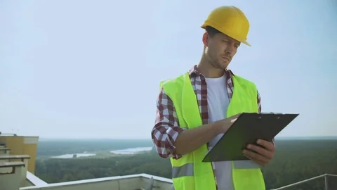 Manager helmet and safety jacket checking construction results holding documents 動画素材 117218942