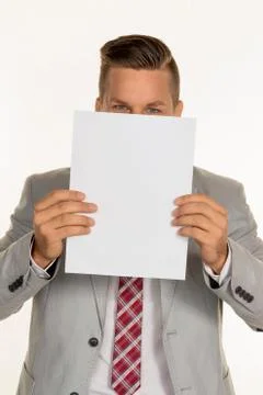 Manager holding blank sheet in front of face Stock Photos