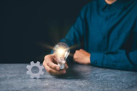 Manager holding light for iDeas, concept of project business gear managemen.. Stock Photos