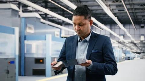 Manager holding processed silicon wafer inside automated manufacturing plant Stock Footage 333394824