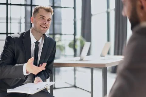 Manager interviewing a candidate in modern office Stock Photos