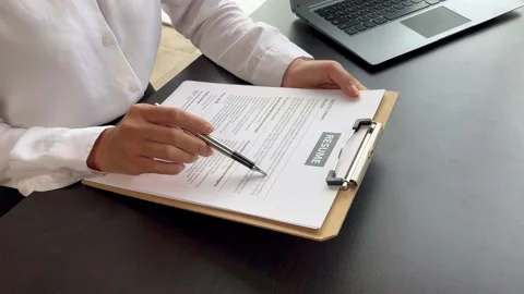 The manager is interviewing job applicants and reading Stock Footage 217506351