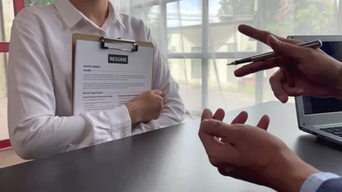The manager is interviewing job applicants and reading Stock Footage 217506360