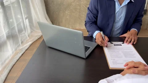 The manager is interviewing job applicants and reading Stock Footage 217506371