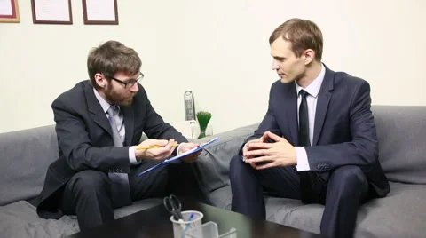 Manager interviewing a male applicant in his office. Two men in business suits Stock Footage 63202950