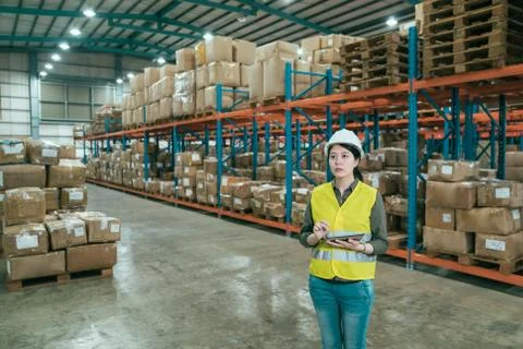 Manager in large warehouse with digital tablet Stock Photos
