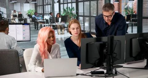 Manager Leads Diverse Team Training On Secure Document Management System. Stock Photos