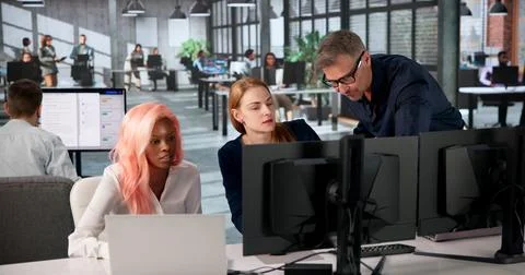 Manager Leads Diverse Team Training On Secure Document Management System. Stock Photos
