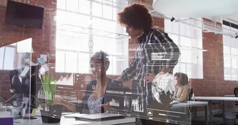 Manager leaning and pointing at tech graph while data analyst zooming into Stock Footage 330106181