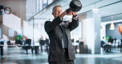 Manager Lifts Kettlebell For Quick Workout Break To Stay Healthy. Stock Photos