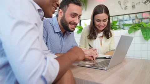 Manager looking at laptop and discuss with team Stock Footage 167792374