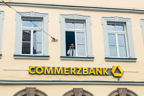 Manager is looking out of the window of the Commerzbank in a german town 스톡 사진