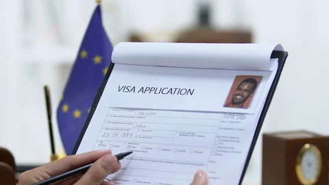 Manager looking through European Union visa application, marking approved Stock Footage 114972985
