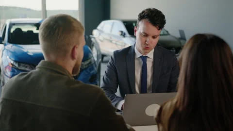 Manager makes an application for the purchase of a new car in the dealership Stock Footage 256074514