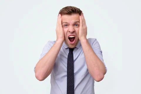 Manager man with a tie is surprised. Studio shot Stock Photos