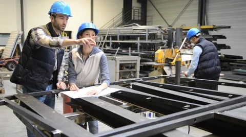 Manager with mechanical worker checking on production plans Stock Footage 46734956