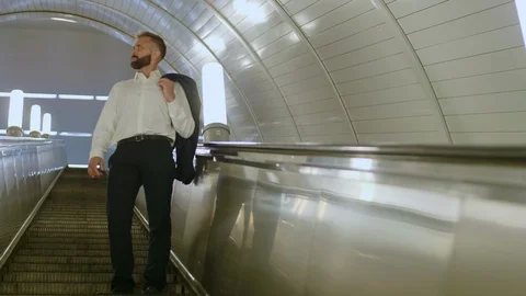 Manager moving up on underground escalator Video stock 120663818