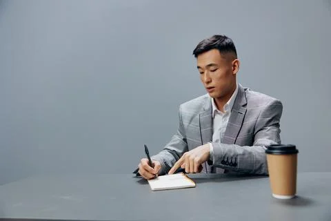 Manager with a notepad glass of coffee on the table sits at the office desk Stock Photos