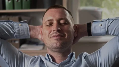 Manager in the office with closed eyes smiling and dreaming of a vacation Stock Footage 307598090