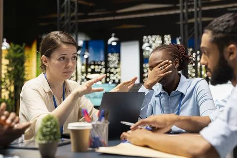Manager in office doing layoffs after evaluating staff performance, bad news Stock Photos