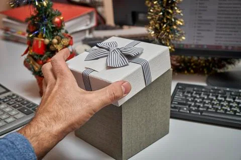 Manager opening a gift box on working place 写真素材