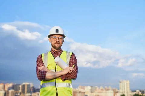Manager or engineer in helmet and safety vest on urban city Photos