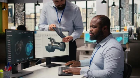 Manager overseeing engineer using CAD app to optimize wind turbine design Stock Footage 315614982