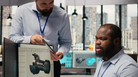 Manager overseeing engineer using CAD app to optimize wind turbine design Stock Footage 316003112